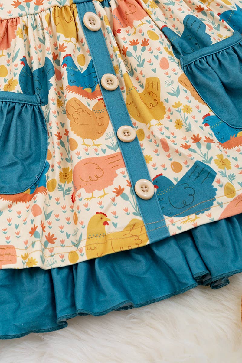 HEN PRINTED DRESS WITH TEAL POCKETS & RUFFLE HEM. LOI: M