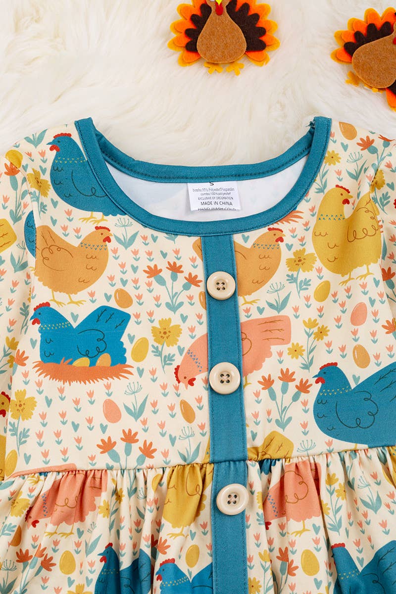 HEN PRINTED DRESS WITH TEAL POCKETS & RUFFLE HEM. LOI: M