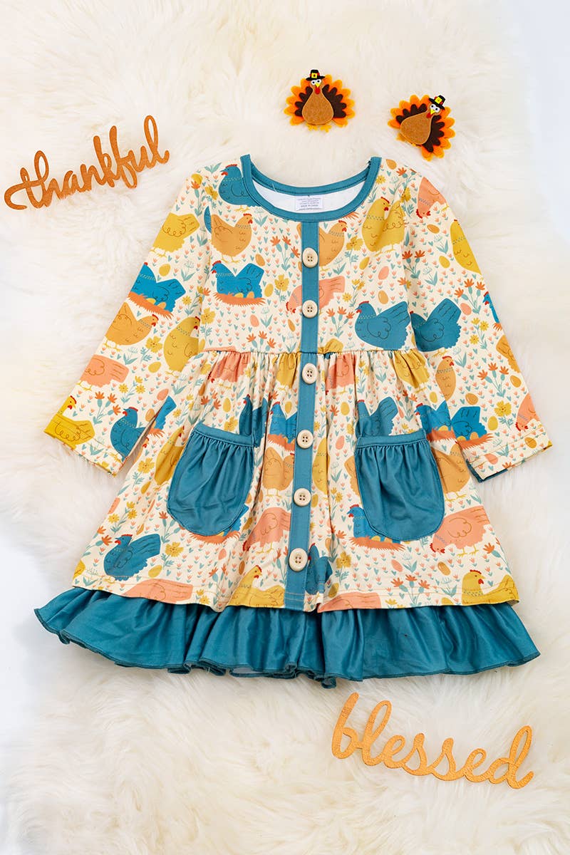 HEN PRINTED DRESS WITH TEAL POCKETS & RUFFLE HEM. LOI: M